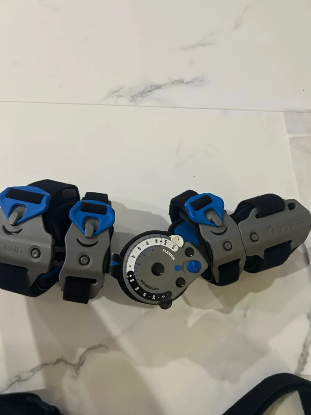 Össur Rebound Post-Op Elbow Brace Adjustable Black Gray Blue, right hand.